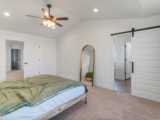 Vaulted ceiling featuring a ceiling fan with integrated lighting, recessed lighting, and carpet flooring