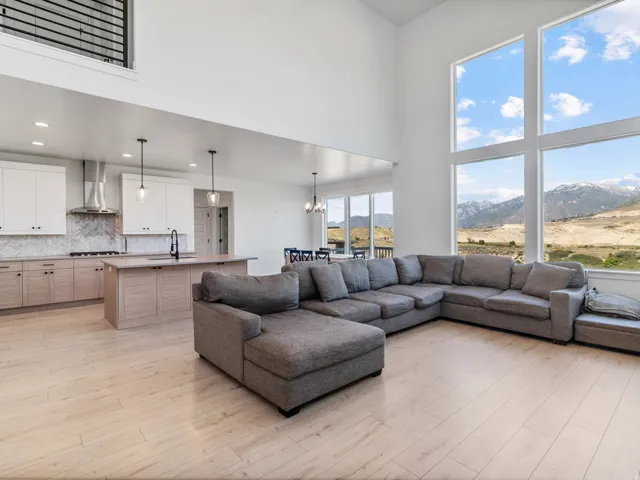 Two-story living area with expansive windows showcasing a mountain landscape