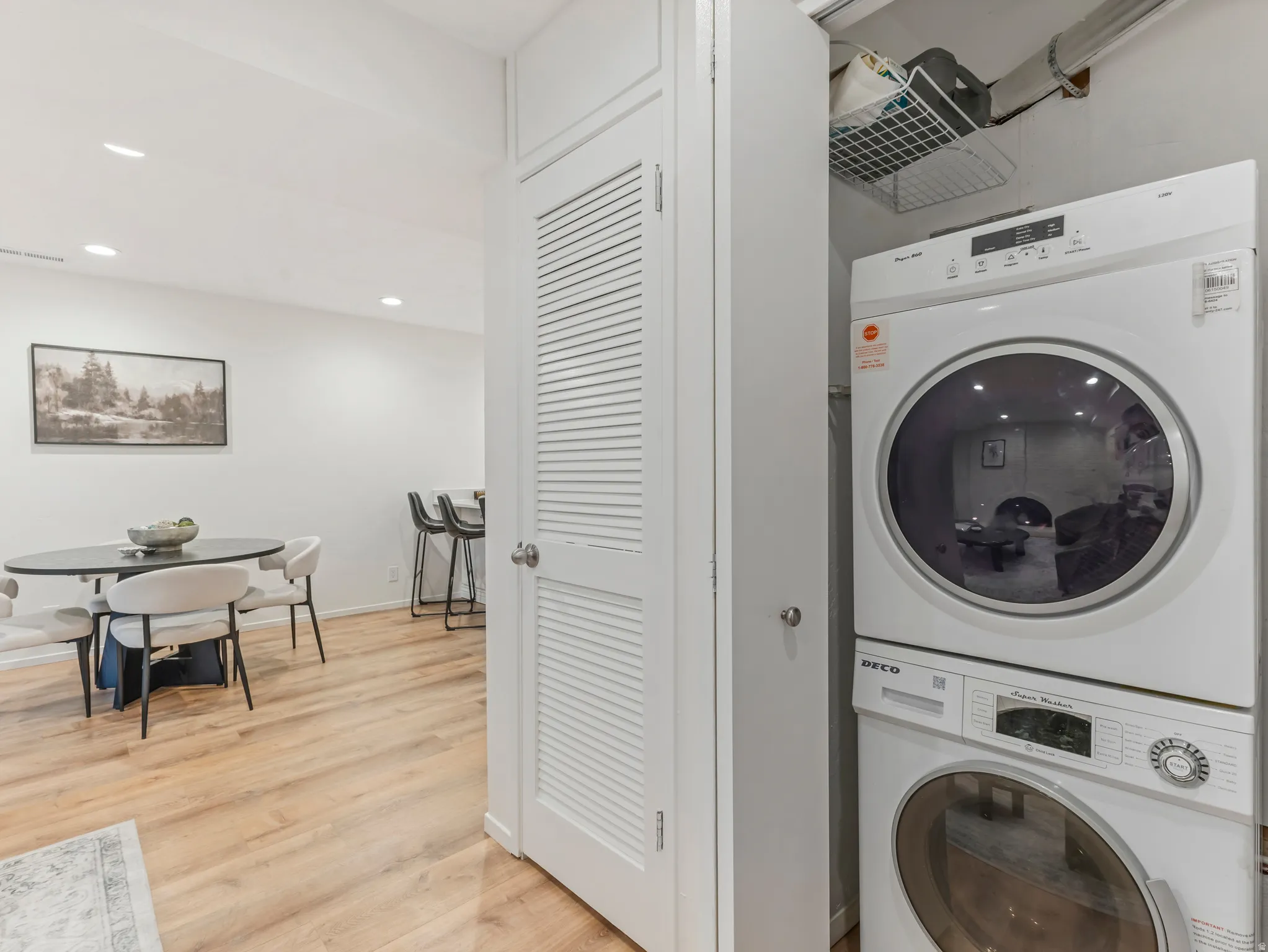 Dedicated laundry area featuring a stacked washer and dryer unit
