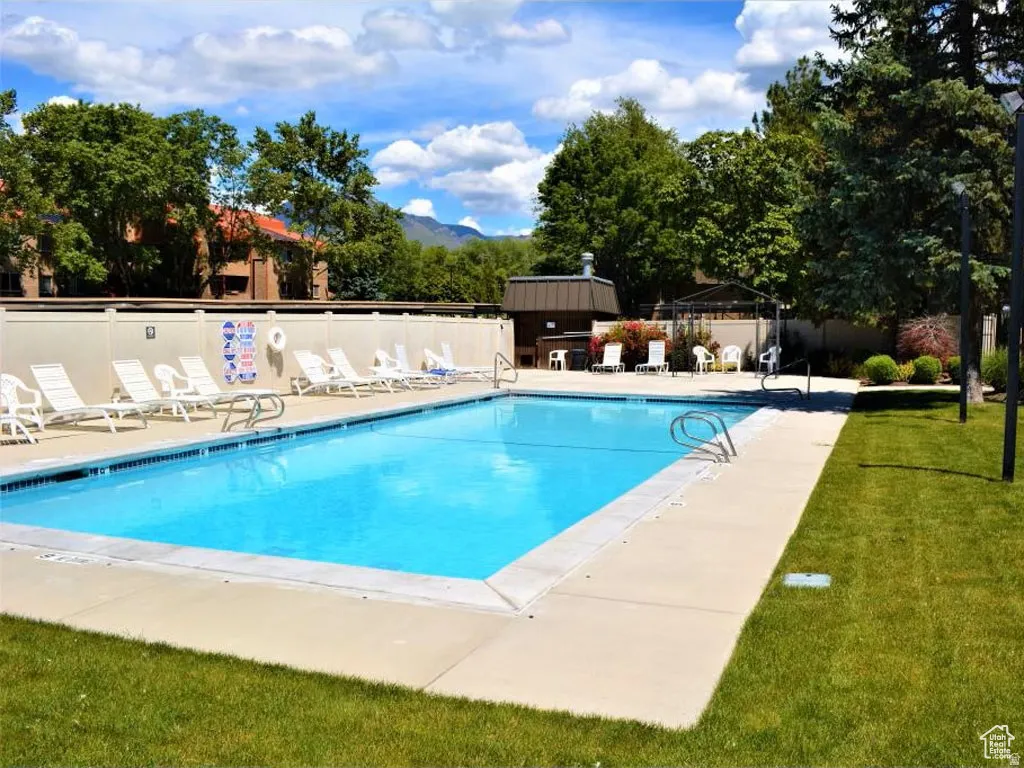 Outdoor swimming pool with integrated steps, surrounded by a concrete deck