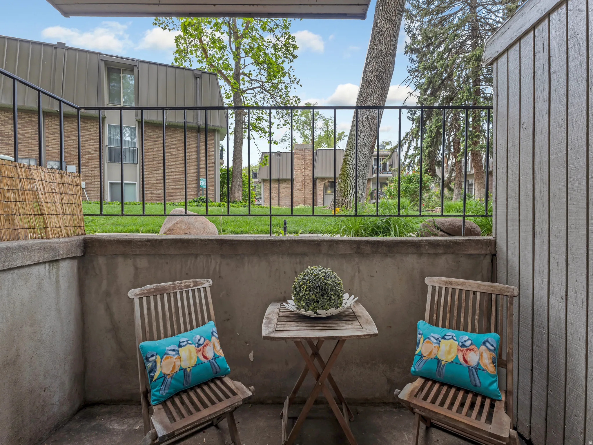 Private patio area featuring a concrete surface and retaining wall