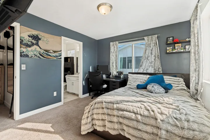 Carpeted room featuring a ceiling-mounted light fixture and a window with white trim