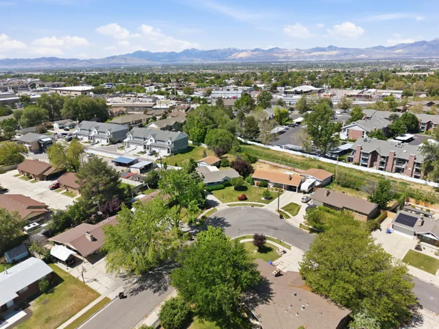 Aerial perspective showcasing a residential neighborhood with diverse housing styles, including single-family homes and multi-story apartment buildings