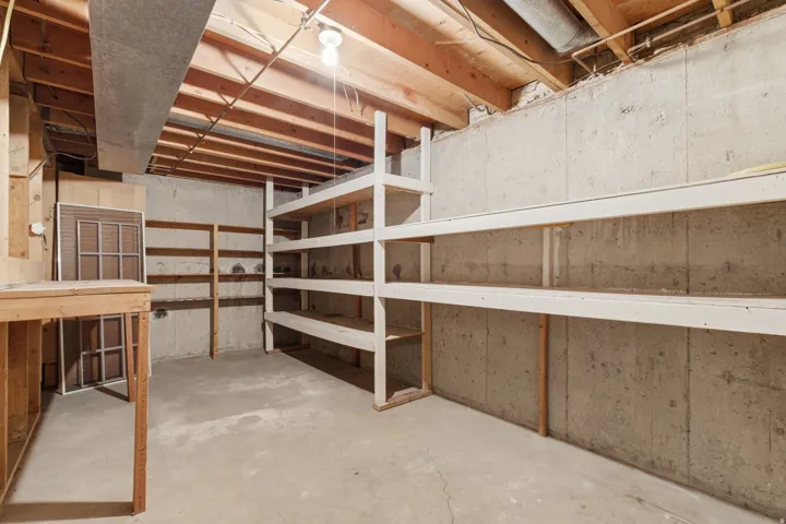 Unfinished basement featuring concrete walls and flooring