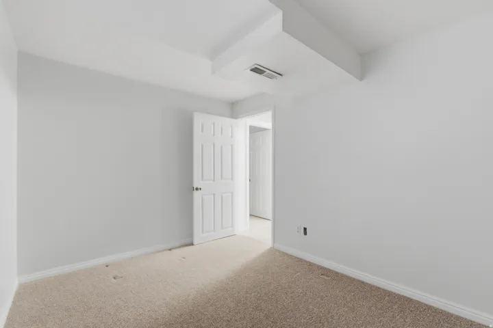 Neutral tone walls with white trim and carpeting