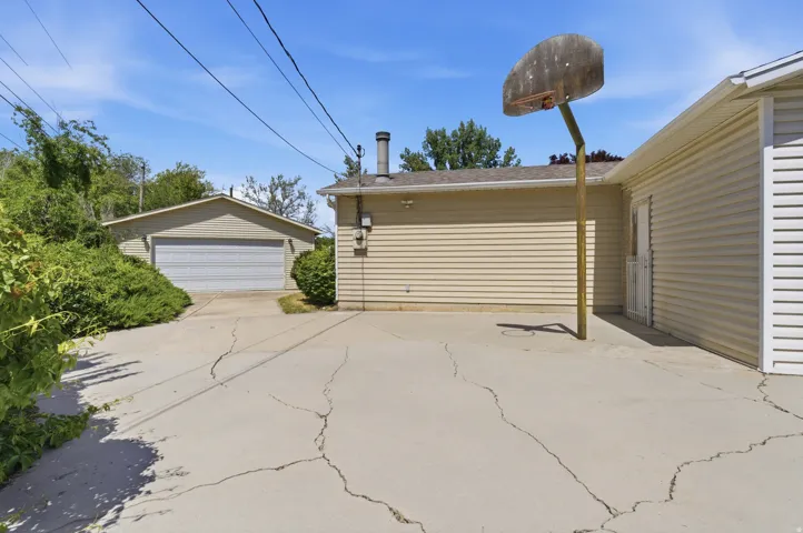 Detached two-car garage with a roll-up door, accompanied by a spacious concrete driveway