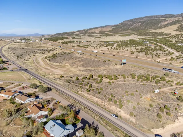 Expansive undeveloped land featuring natural desert vegetation, rolling hills, and distant mountain backdrops