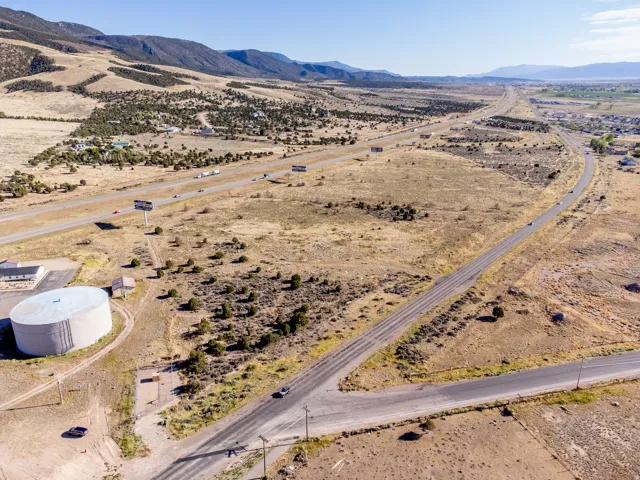 Expansive undeveloped land featuring a paved road frontage and direct highway access