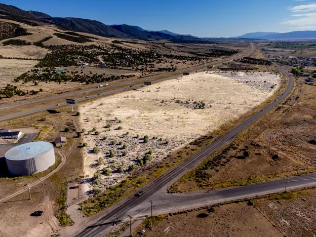 Expansive land parcel featuring direct highway frontage and mountain scenery