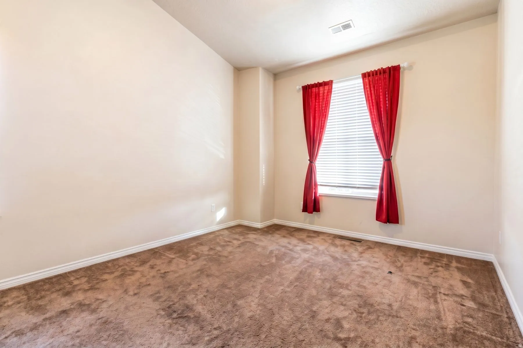 Furniture removed by AI. Neutral-toned walls complement the textured brown carpet