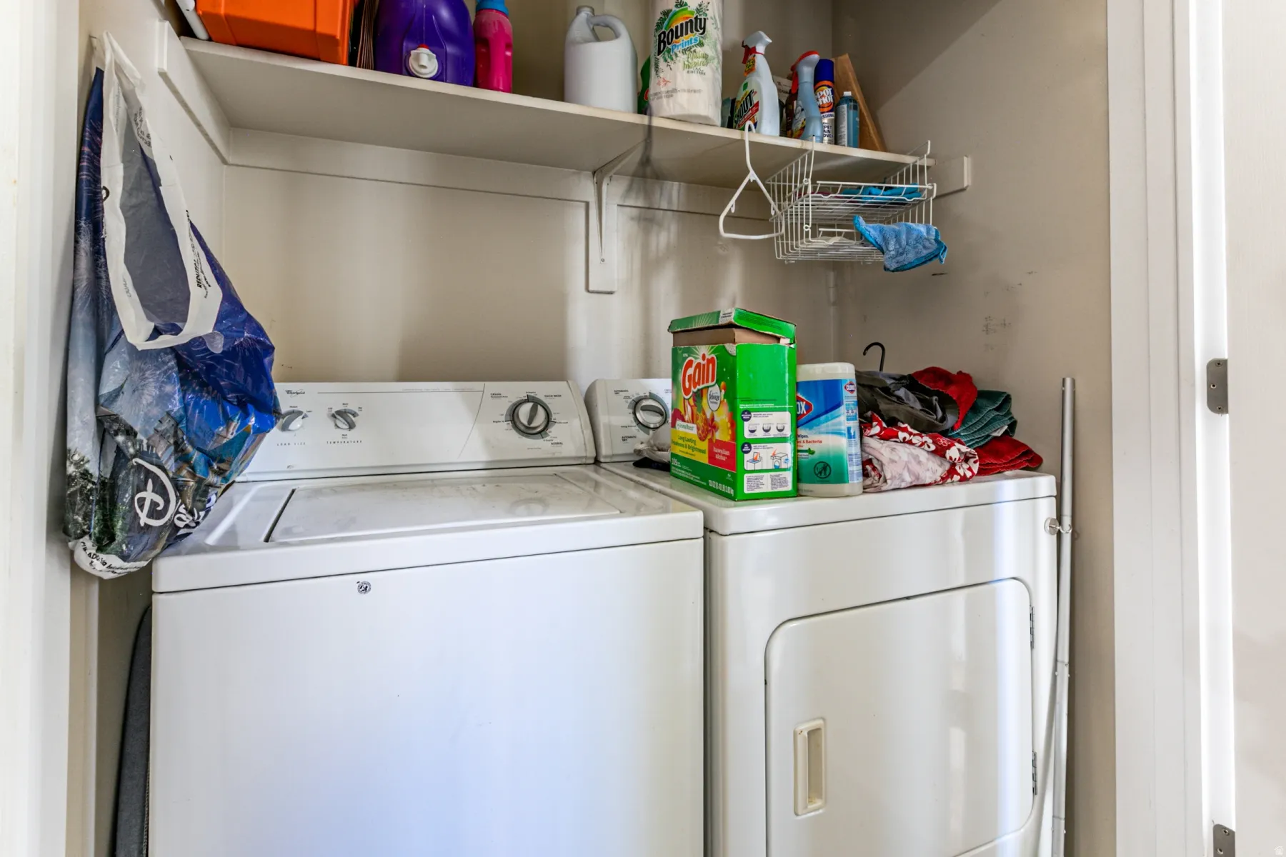 Dedicated laundry area featuring a white top-load washing machine and a white front-load dryer