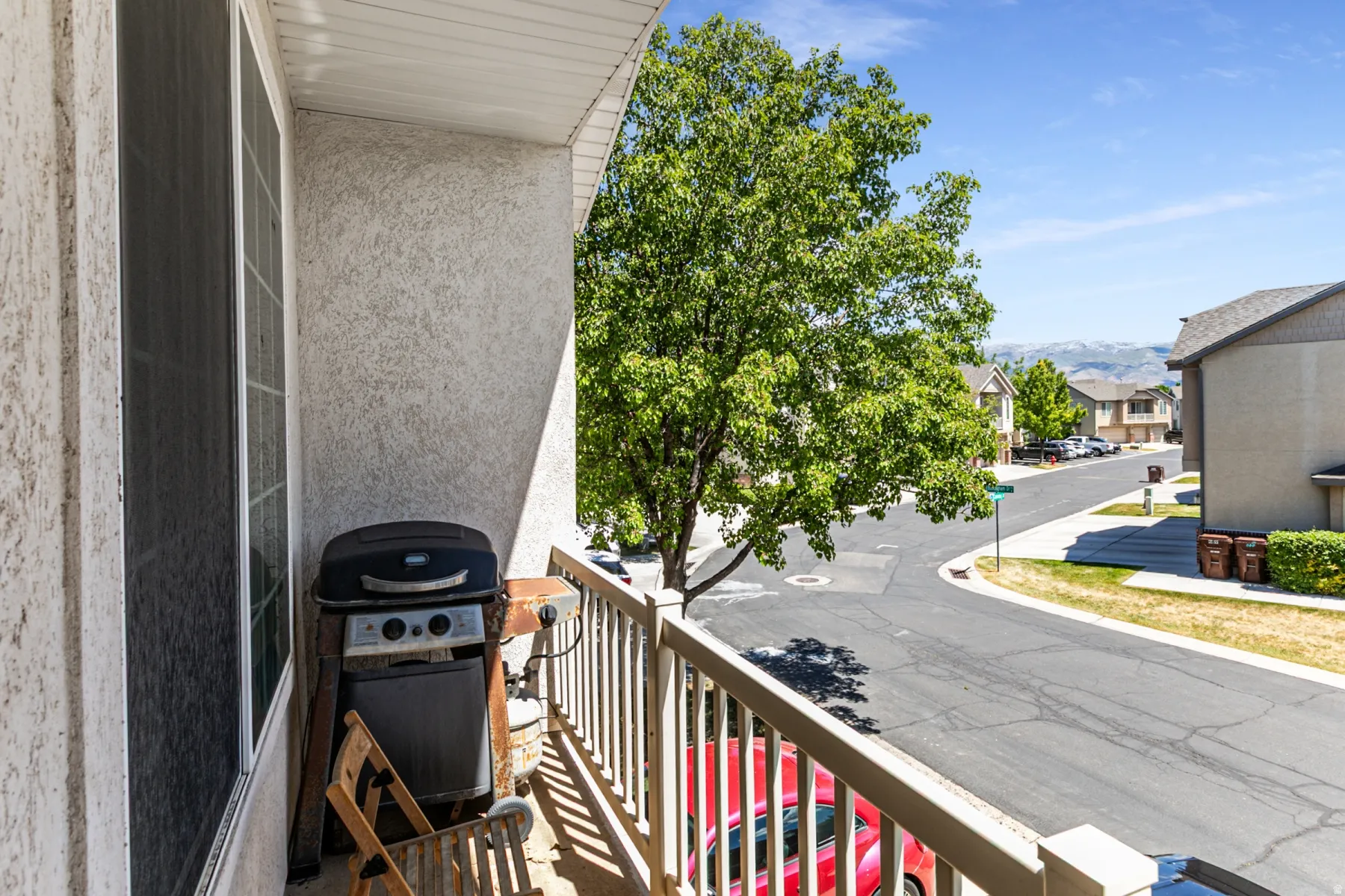 Private balcony with textured exterior finish and painted railing