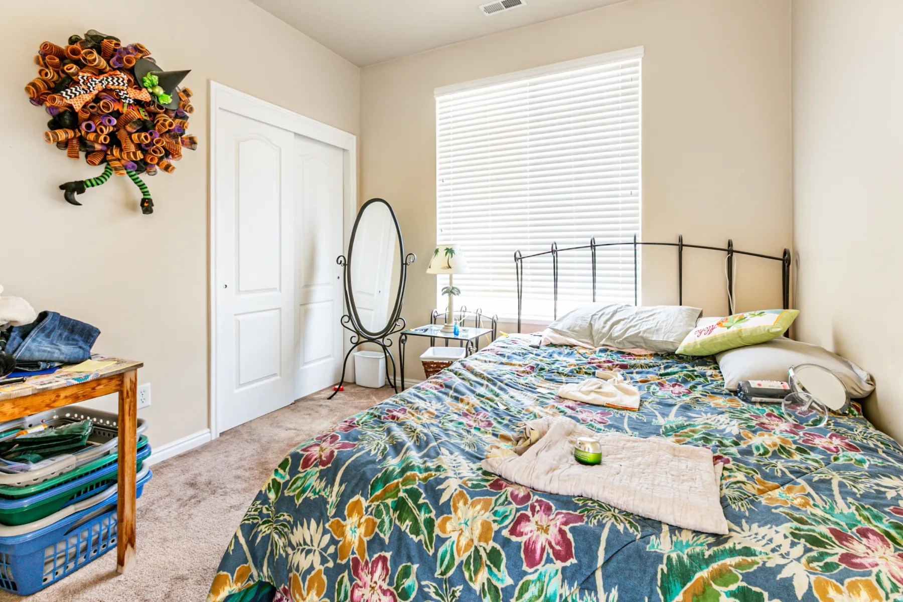 Carpeted room with a double-door closet featuring white paneling