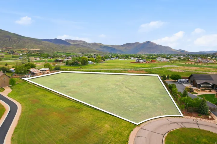 Expansive residential lot featuring a level, grass-covered terrain