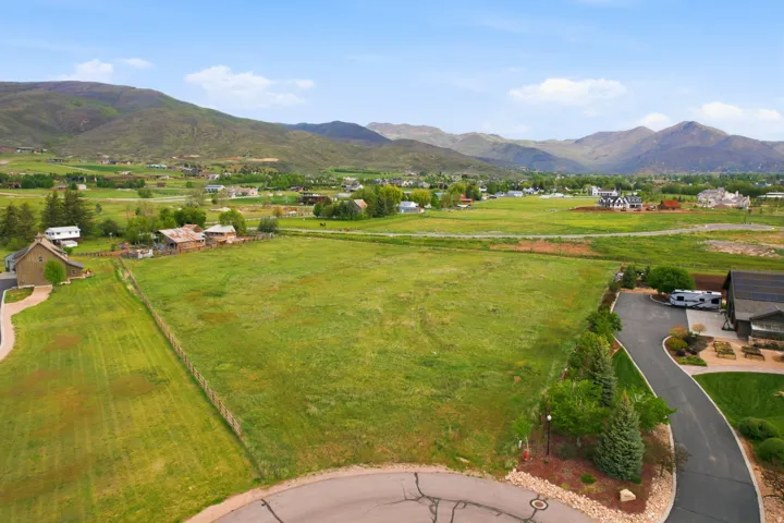 Expansive green land parcel featuring distant mountain ranges