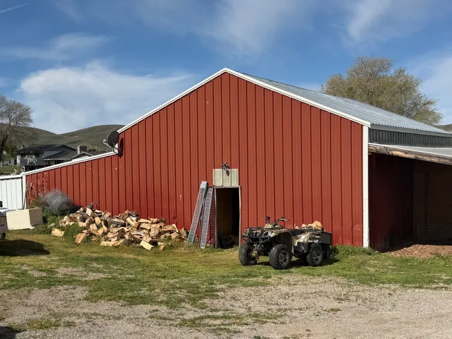 Red barn with vertical siding and a corrugated metal roof