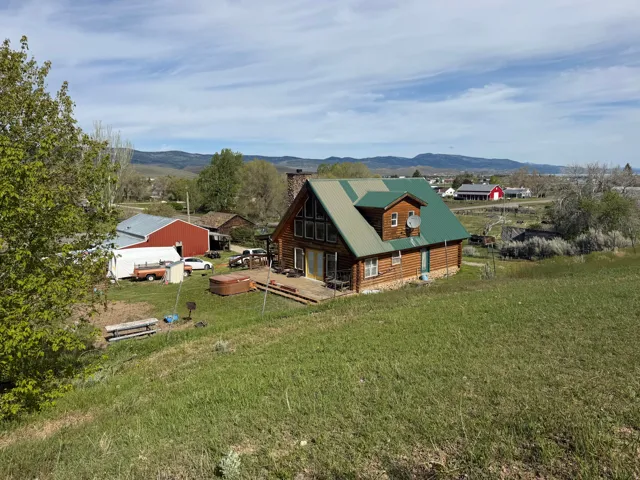 Log cabin exterior with a green metal roof