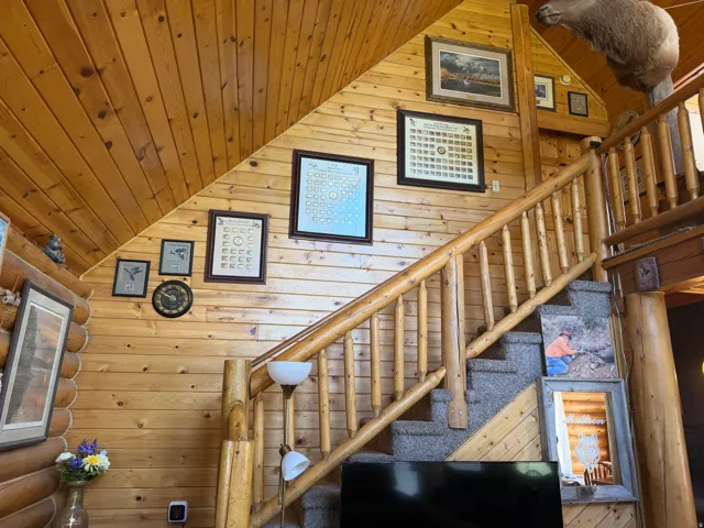Rustic wood-paneled walls and sloped ceilings define this interior space