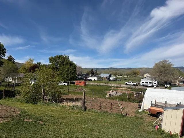 Expansive property featuring a combination of cultivated garden space and open grassy areas