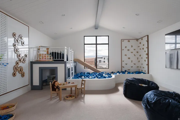 Versatile bonus room featuring a built-in play structure with a slide, a recessed pit, a climbing wall, and recessed lighting
