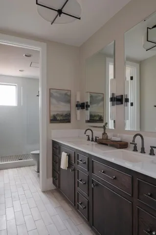 Dual vanity with dark wood cabinetry, white countertops, and matte black hardware