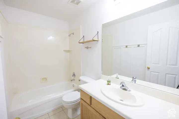 Full vanity with integrated sink, chrome faucet, and wood-finish cabinetry