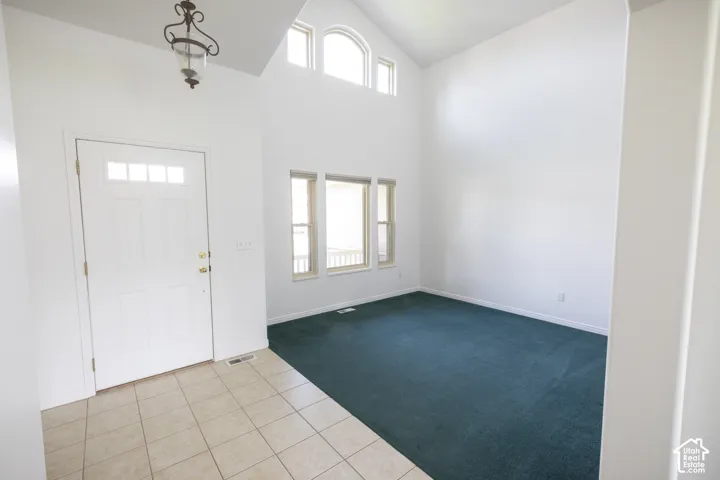 Vaulted ceilings, transom windows, and an arched window provide abundant natural light
