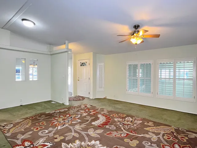 Living area featuring a textured ceiling, recessed lighting, and a ceiling fan