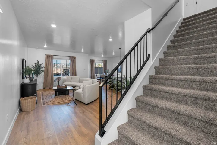 Carpeted staircase with contemporary black metal railing