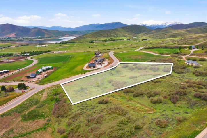 Expansive undeveloped land parcel featuring natural shrubbery and surrounding green hills
