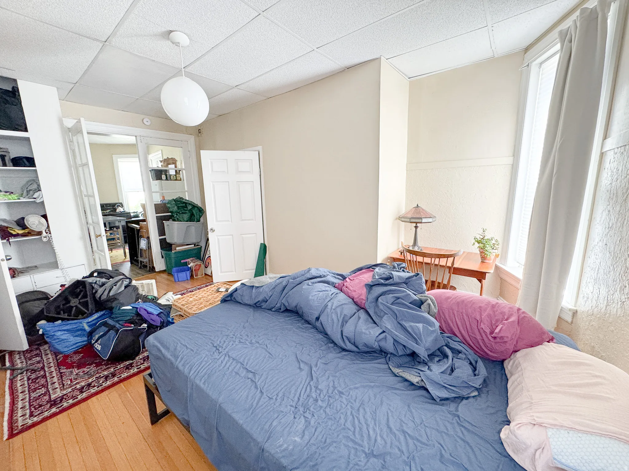 Wood-finish flooring with a white drop ceiling