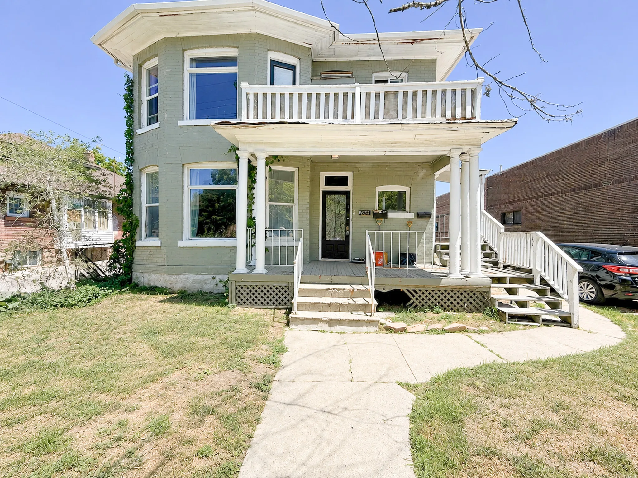 Two-story structure featuring a full-width front porch with classical columns