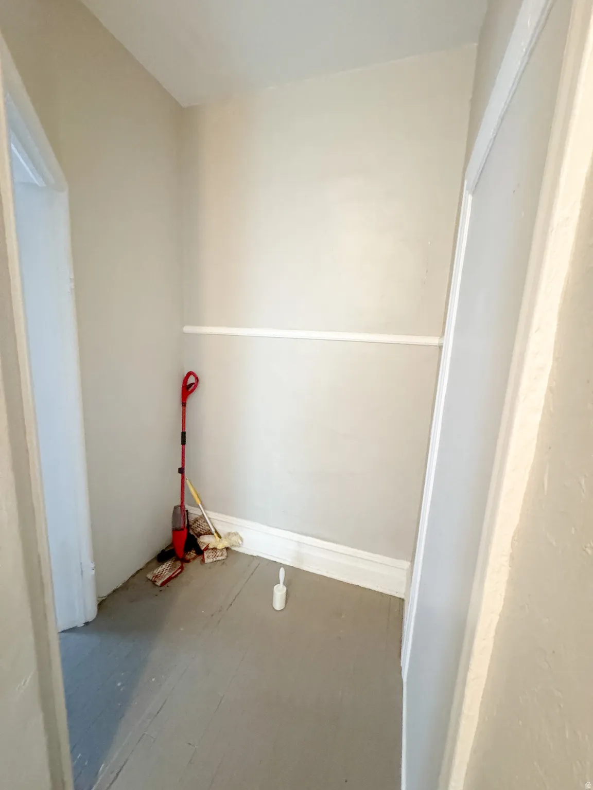 Recessed alcove featuring light-toned walls, white baseboards, and a white chair rail molding