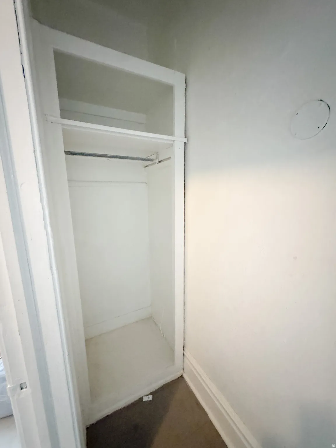 Recessed closet space featuring a clothing rod and upper shelf