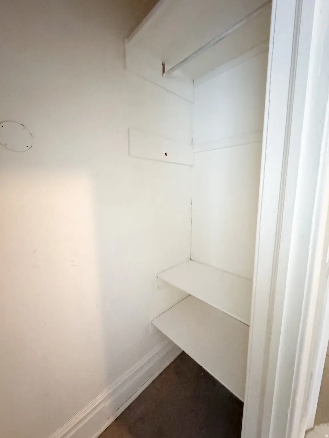 Built-in closet with overhead shelf, clothing rod, and two lower shelves
