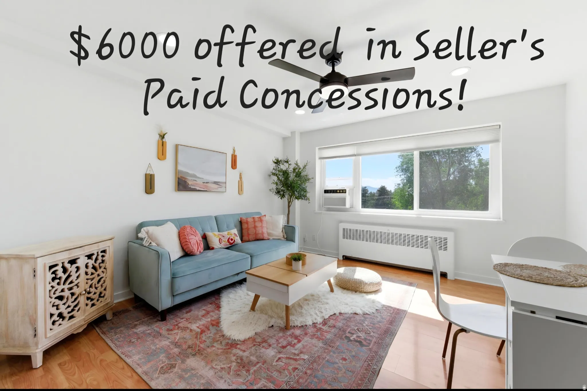 Living space featuring wood-finish flooring, white walls, and a prominent window with a window-mounted air conditioning unit