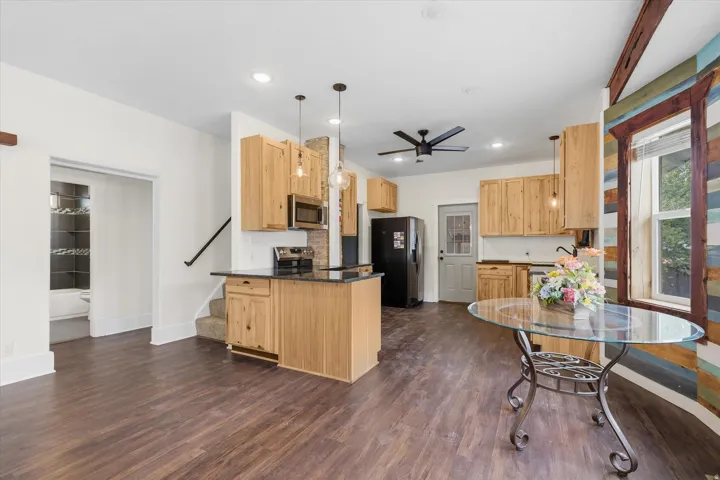 Open-concept kitchen and living area featuring wood-finish type LVP flooring