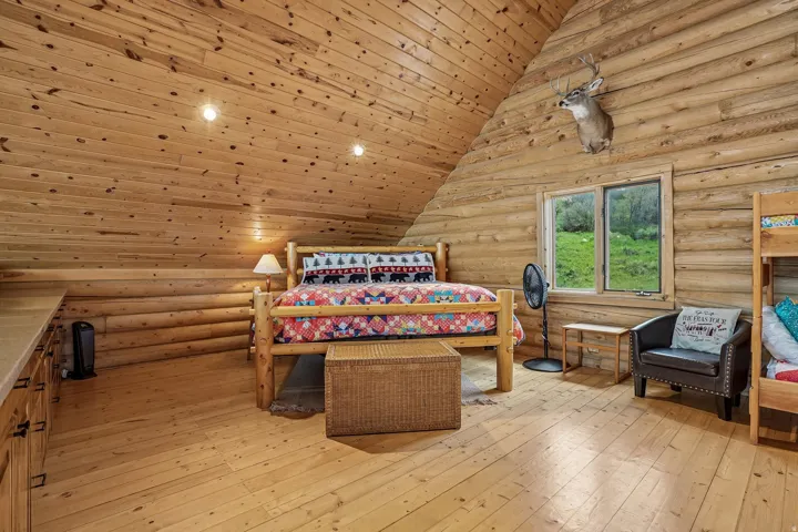 Interior room featuring log construction walls and wood-finish flooring