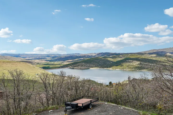 Expansive lake and mountain scenery featuring natural terrain and distant foothills