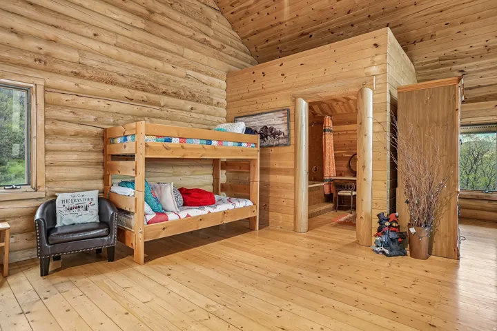 Expansive wood-finish flooring extending into an adjacent room