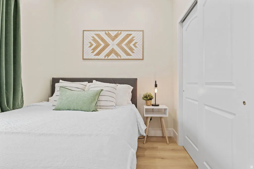Bedroom featuring light wood-finish flooring and a neutral color palette