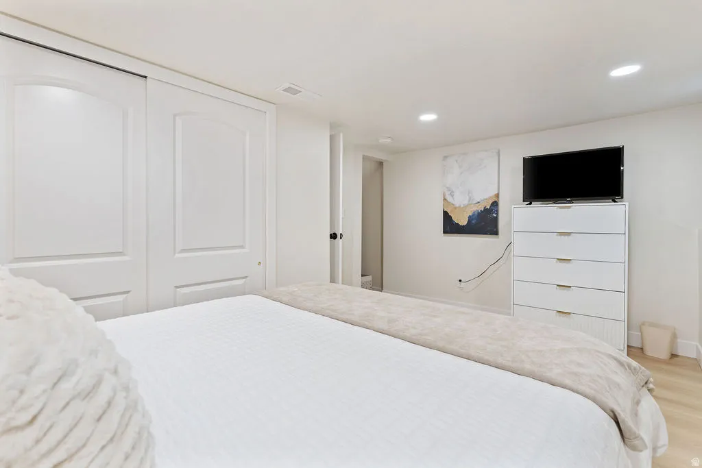 Recessed lighting illuminating light wood-finish flooring