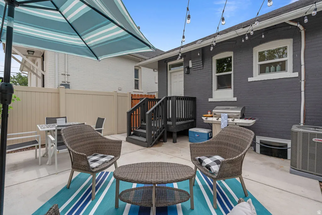 Expansive concrete patio area with a privacy fence