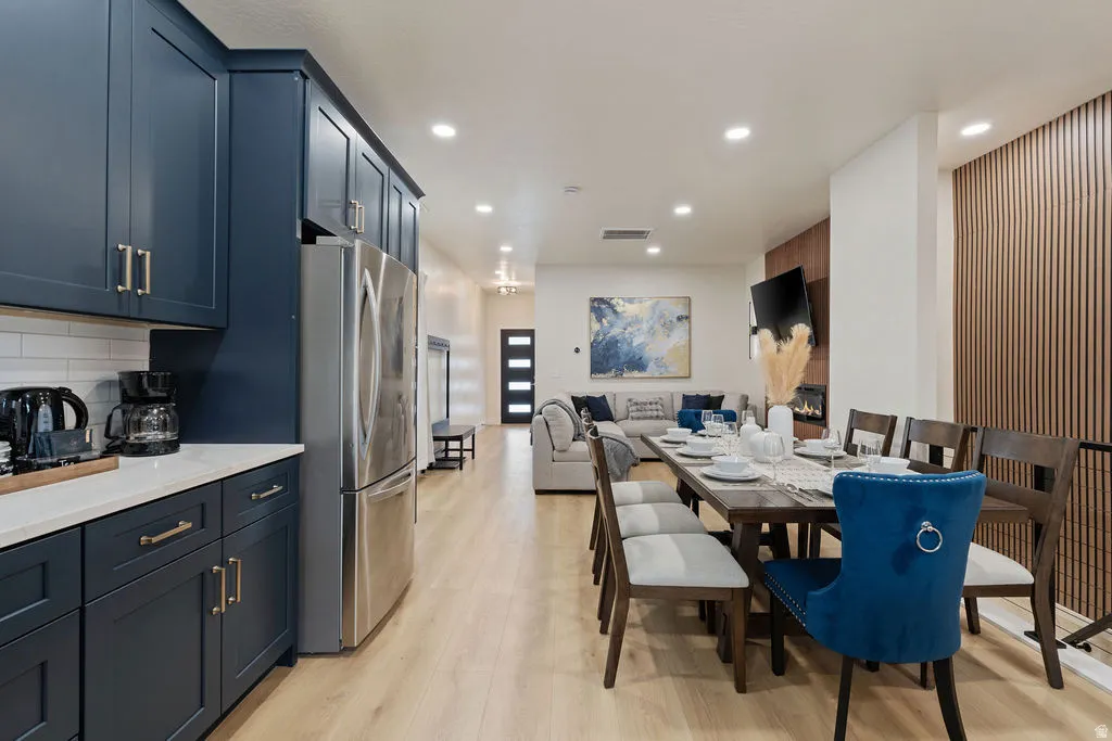 Open-concept living space with light wood-finish flooring