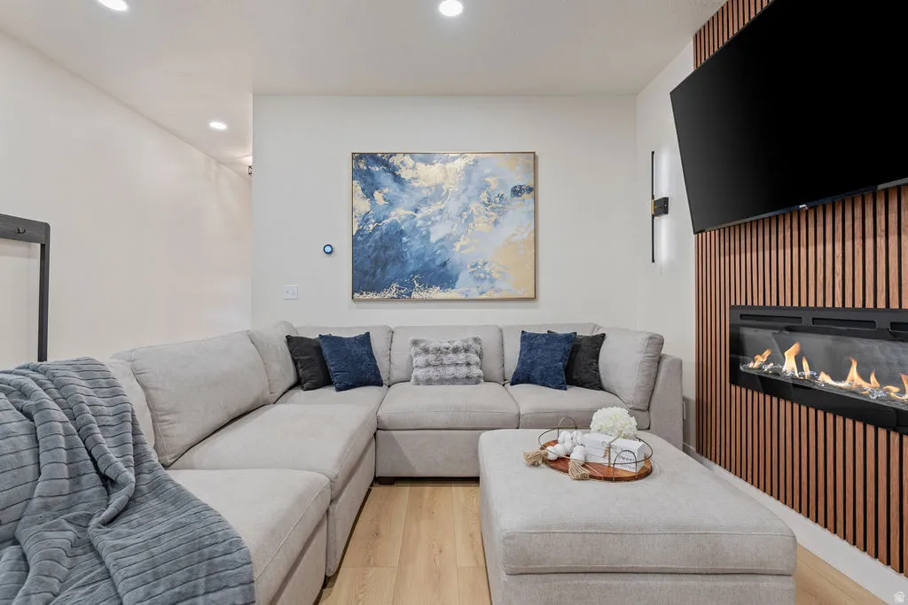 Living space featuring wood-finish flooring and recessed lighting