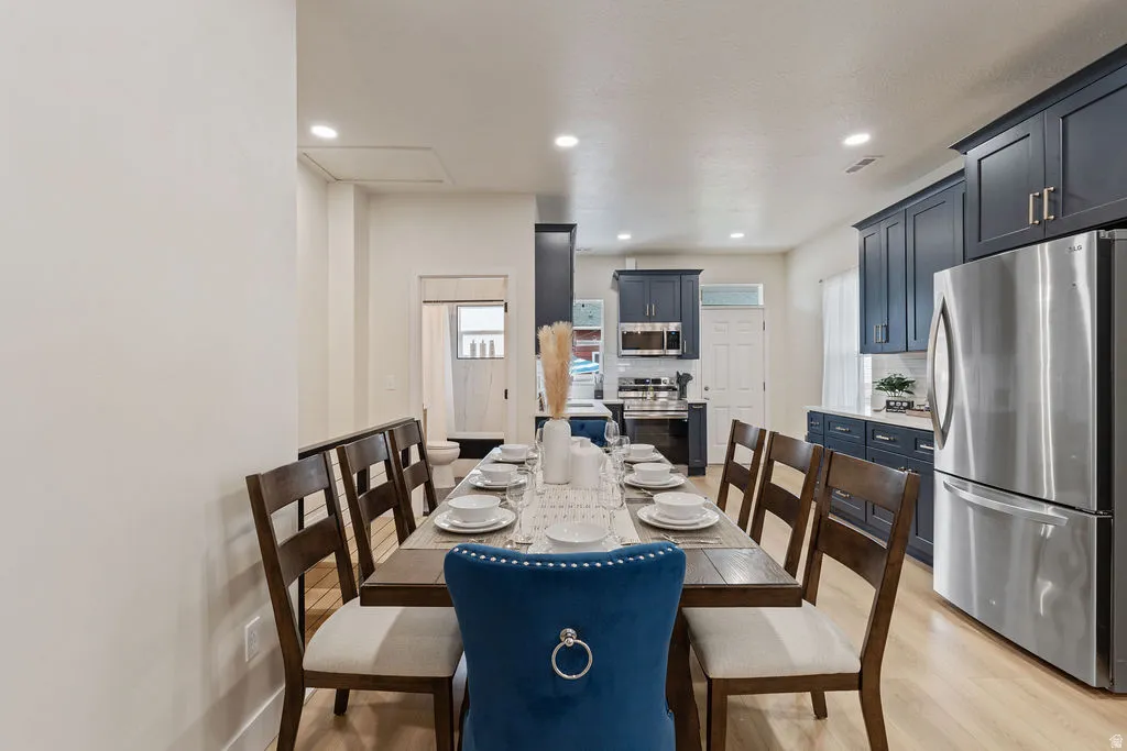 Open concept dining area with wood-finish flooring