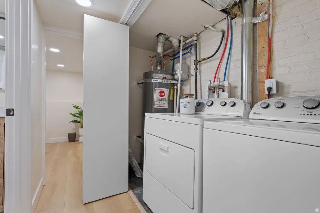 Dedicated laundry area featuring a white washer and dryer pair