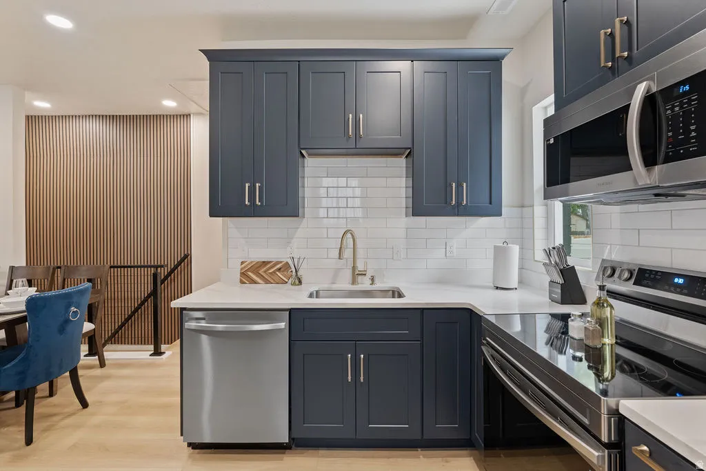 Contemporary kitchen featuring dark blue shaker-style cabinetry
