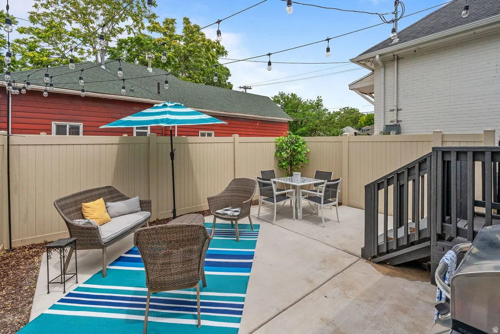 Expansive concrete patio with string lighting overhead