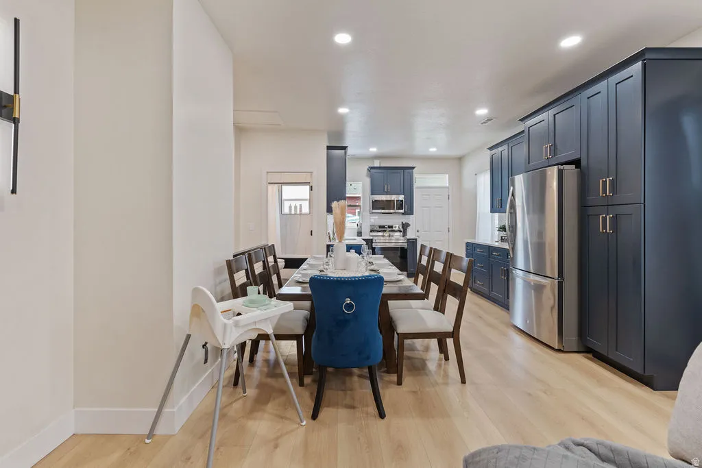 Expansive dining area featuring wood-finish flooring and recessed lighting